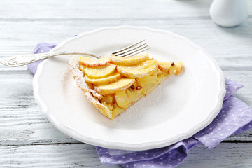 Slice of tart with apples on a plate