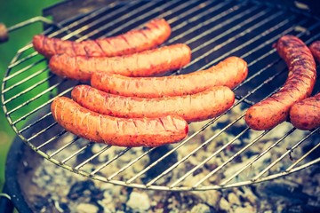 Vintage photo of tasty polish sausage on grill