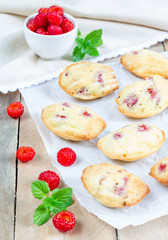 Fototapeta na wymiar Madeleines cookie with raspberry on parchment paper