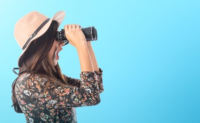 Surprised woman with binoculars