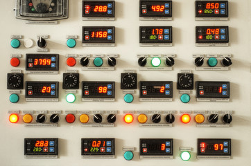 Industrial factory control panel with switches and digital indicators