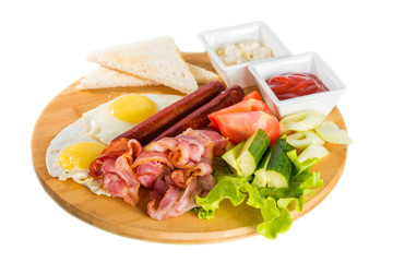 Toasts, fried egg, sausages, meat and vegetables
