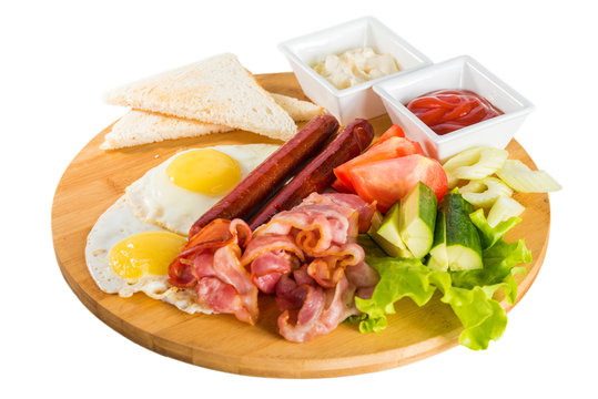 Toasts, fried egg, sausages, meat and vegetables

