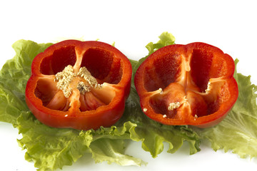 Cutted sweet red pepper on salad leaves