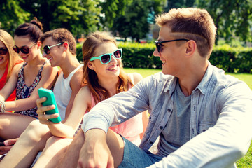 smiling friends with smartphone making selfie