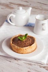 mini cake with chocolate cream and milk, close up