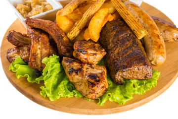 Roasted meat, sausages with corn and sauce

