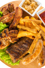 Roasted meat, sausages with corn and sauce
