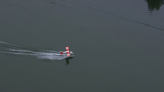 Float plane takes off from lake, Alaska