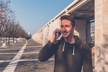 Young  handsome man talking on phone