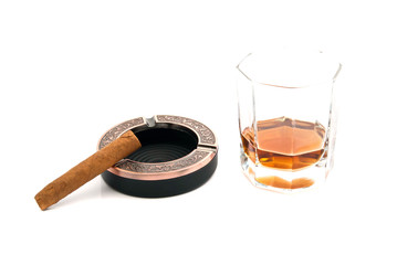 single cigar in ashtray and cognac