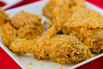 Crispy fried chicken on white plate closeup
