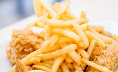 French fried with crispy fried chicken closeup