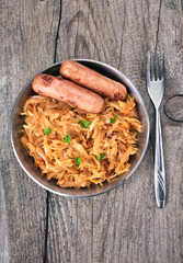 Stew cabbage with grilled sausages