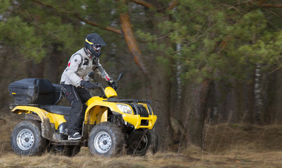 Man riding dirty 4x4 ATV quad bike