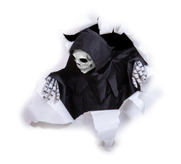 Grim reaper looking through hole torn in white paper