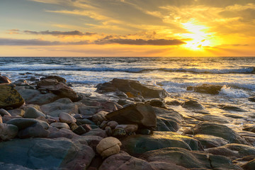 Fototapeta na wymiar Dramatic sunset on the rocky beach, South Australia