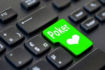 Close up of a green return key with the word poker on computer keyboard