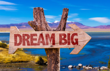 Dream Big direction sign with landscape background