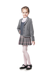 Beautiful little girl in school uniform isolated on white