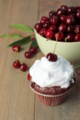 Chocolate Cupcakes with cherries on wooden background