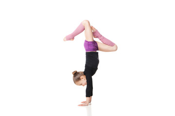 pretty little girl doing gymnastics over white background