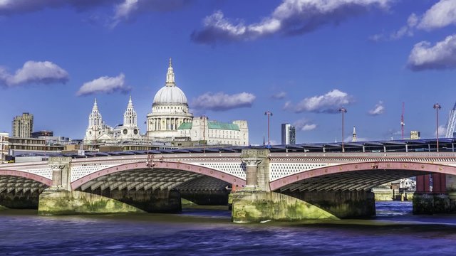 Timelapse view of St Paul cathedral and Blackfriars bridge in London in a late afternoon with blue sky and clouds