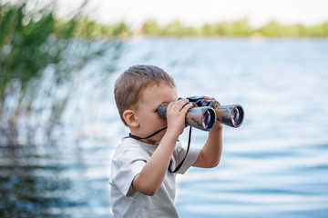 Little boy looking through binoculars
