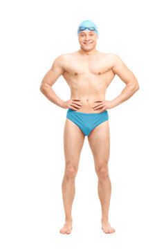 Muscular swimmer with a swim cap and goggles