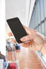 hand using Smartphone in the airport