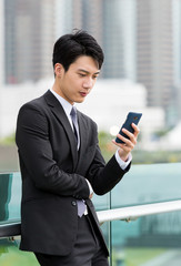 Asian businessman watch on cellphone