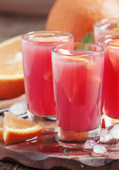 Fresh juice from an orange and  Sicilian orange, selective focus