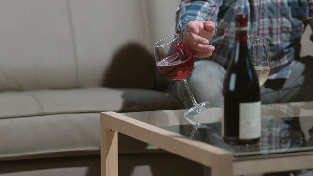 Man knocks over wine glass in slow motion