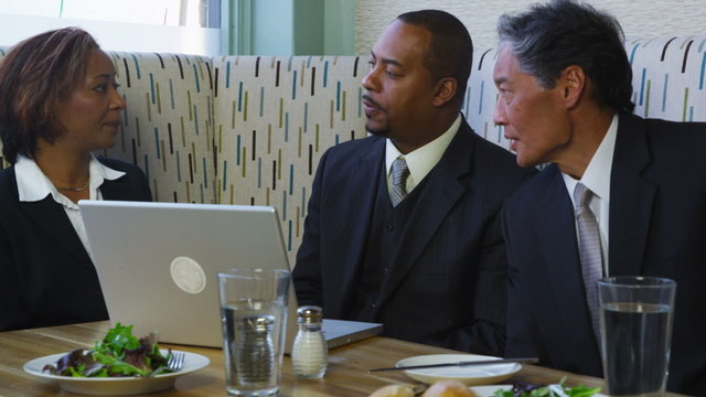 Group of business people having meeting in restaurant