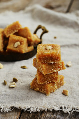 Homemade indian sweets with chickpea flour, coconut flakes, card