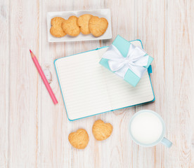 Cup of milk, heart shaped cookies, gift box and notepad