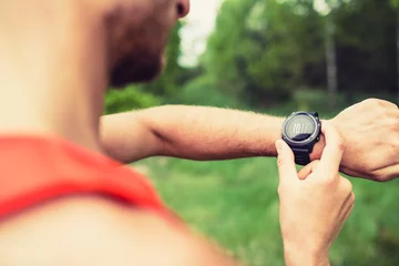 Photo sur Plexiglas Jogging Runner looking checking sport watch