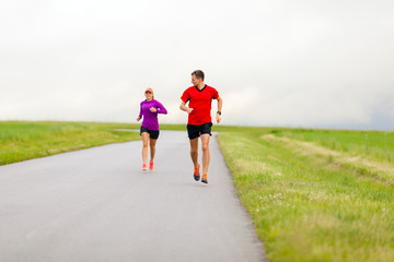 Fototapeta premium Couple running on country road