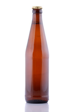 Closed, brown beer bottle on a white background.