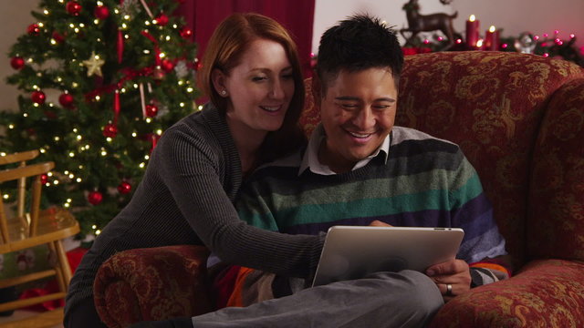 Couple looking at digital tablet together during holidays