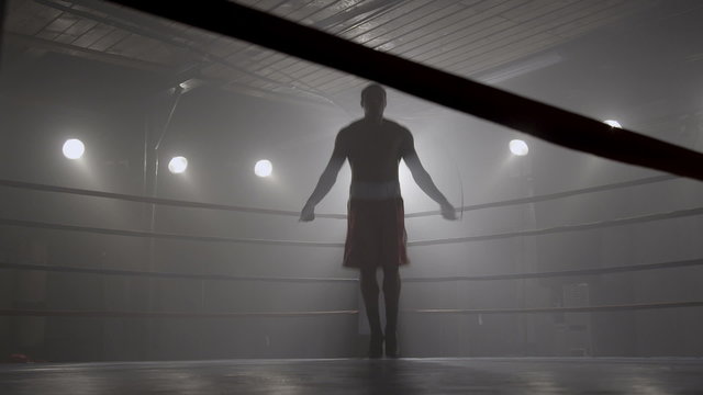 Boxer jumping rope in boxing ring