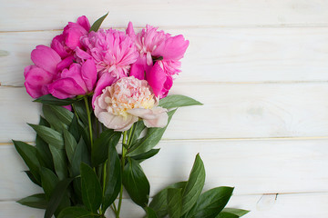 bouquet of beautiful flowers on a white wooden background. Pink and white peonies