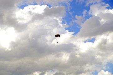 parachutist in cloudy sky