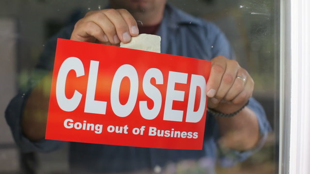 Going out of business, closed sign on window