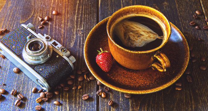 The vintage camera and coffee with strawberry