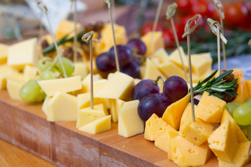 Cheese and grape on the wooden board
