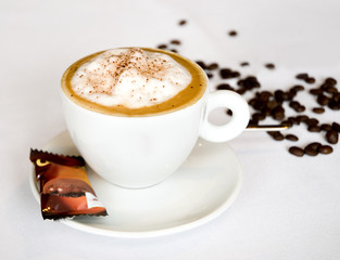 Cappuccino coffee with beans on a table in restaurant