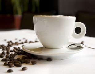 Cappuccino coffee with beans on a table in restaurant