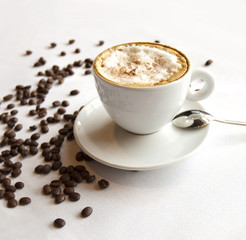Cappuccino coffee with beans on a table in restaurant