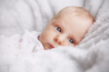 Newborn Baby Girl in White Blankets